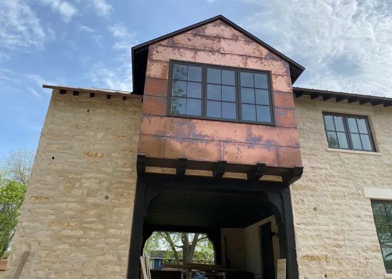 Copper metal panel facade on a stone building for Metal Roof Coating in Oatfield